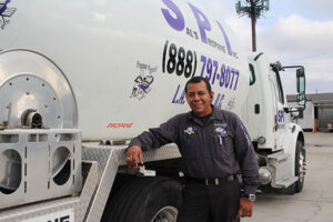 Driver standing next to propane truck
